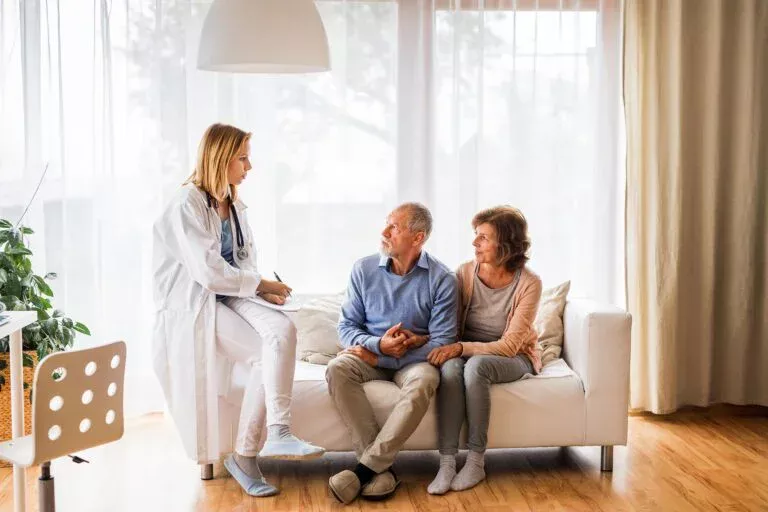 Female Doctor Talking To A Senior Couple